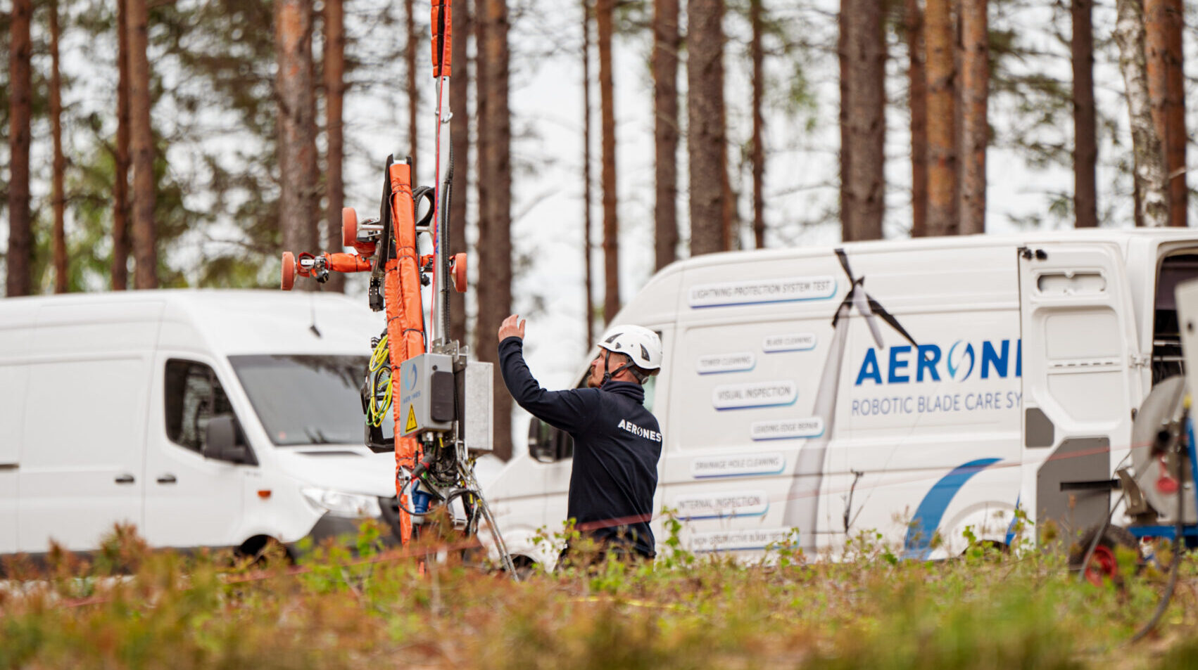Aerones field operations — technicians preparing robotic system at base of wind turbine