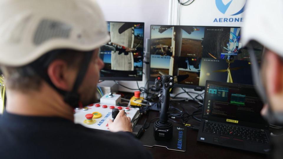 Aerones technicians monitoring robot operations from ground control
