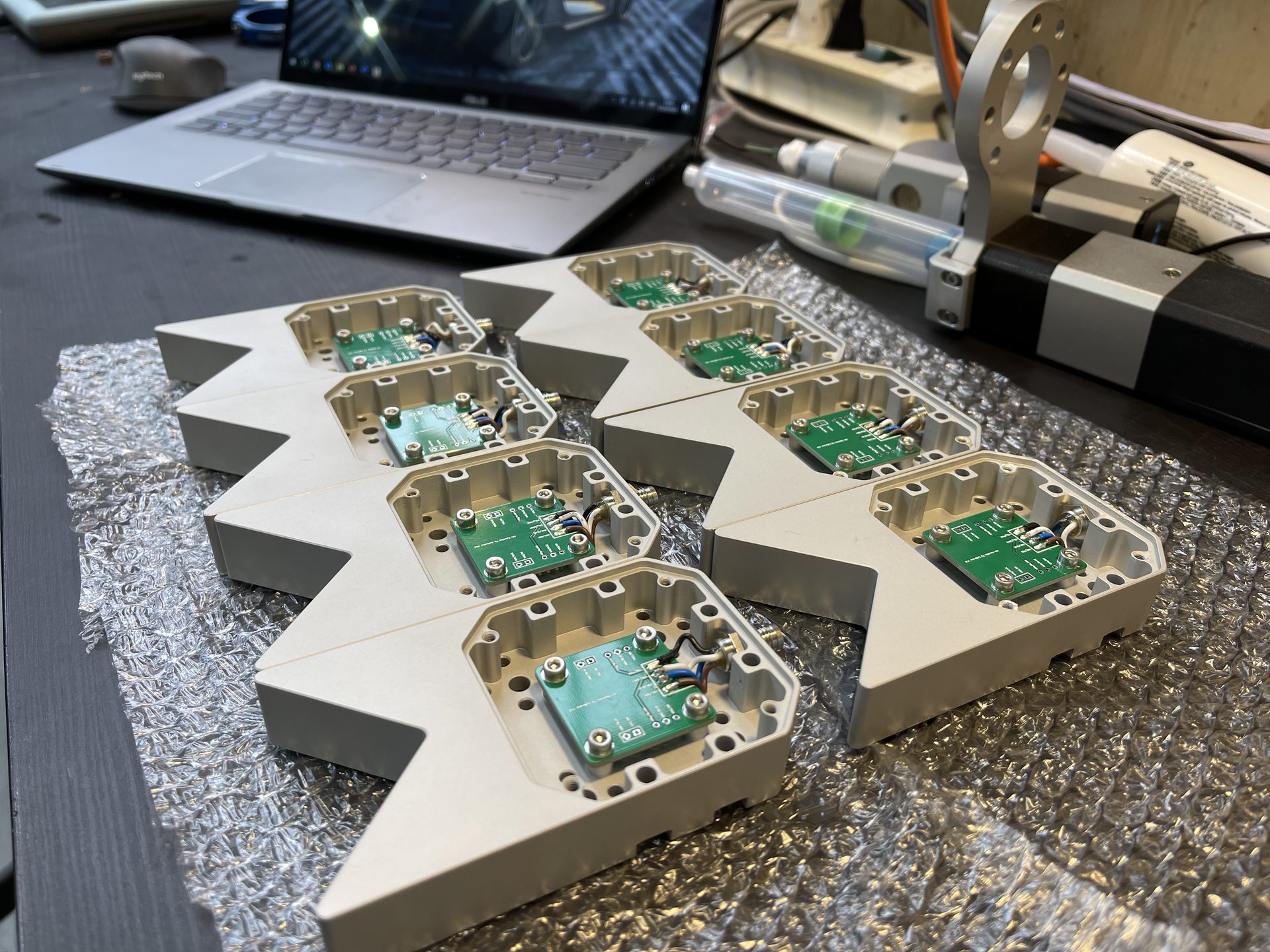 CNC-machined aluminum dispenser housings with custom PCBAs installed — electronics integration during production assembly