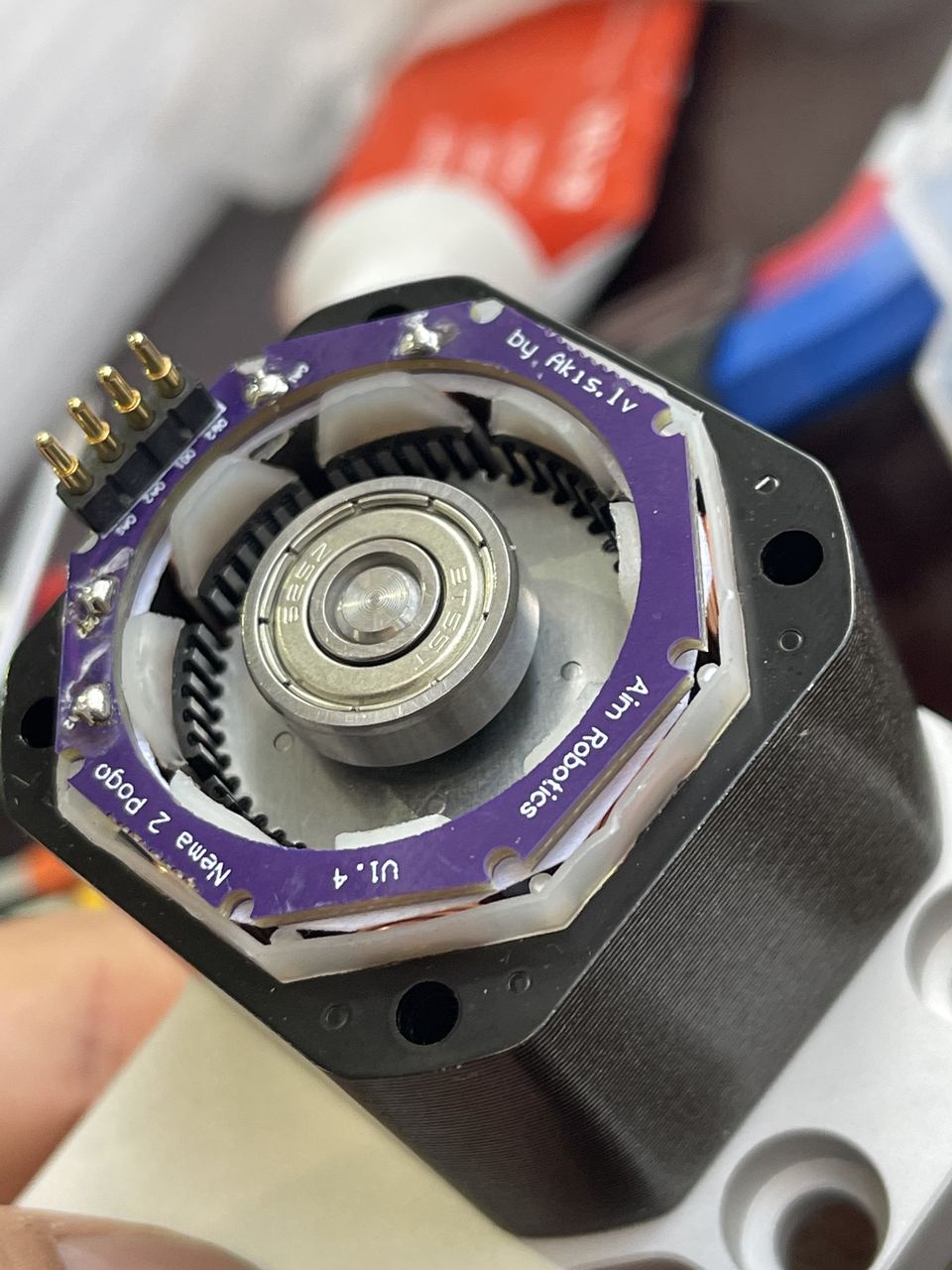 Custom AimRobotics motor with planetary gearbox — purple encoder PCB reads 'Aim Robotics' and 'by Akis.lv'