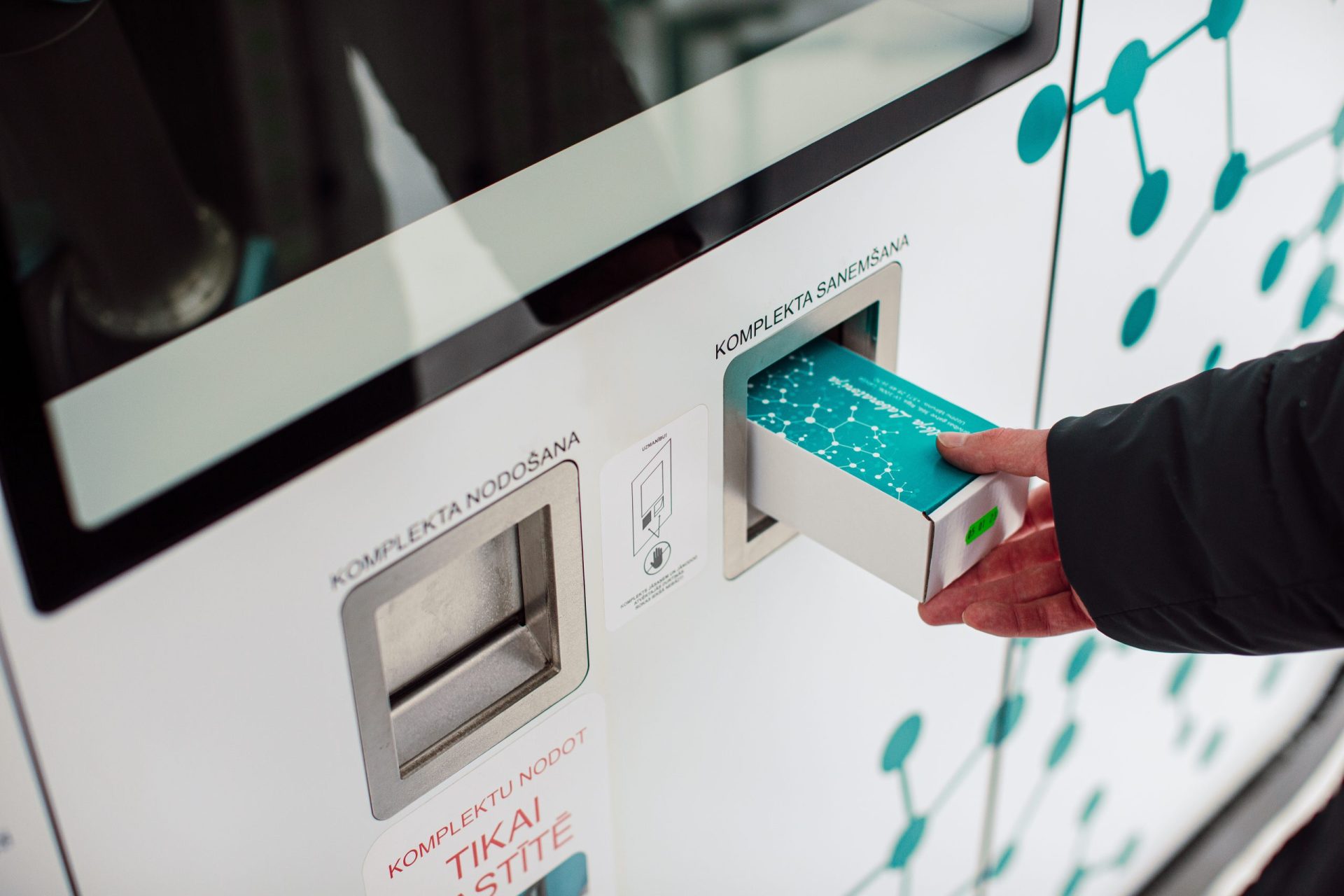 NOVALab self-sampling kiosk — wide view showing terminal design and public deployment