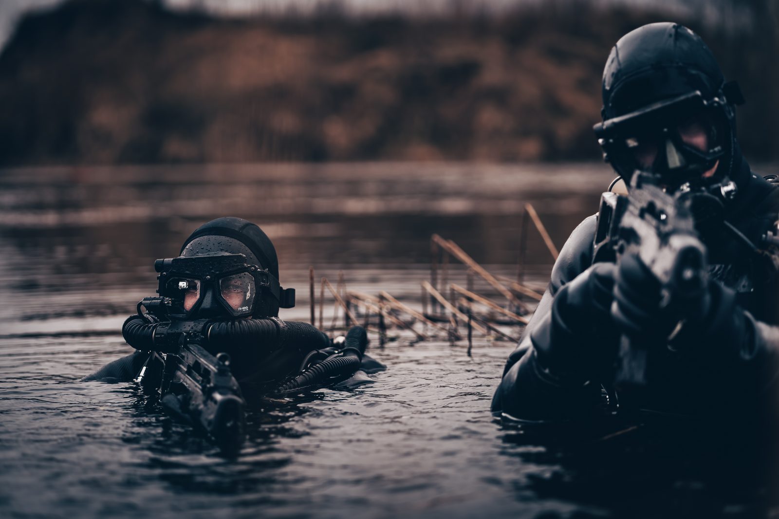 Two tactical divers in water wearing Rheo Dive masks — HUD displays visible through lenses