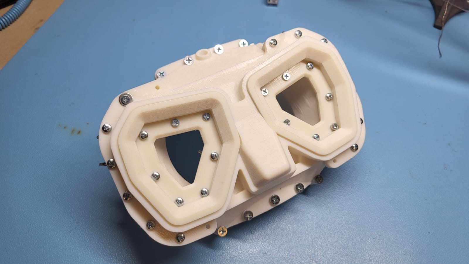 First 3D-printed silicone skirt mold for Rheo Dive mask — white prototype mold with alignment screws