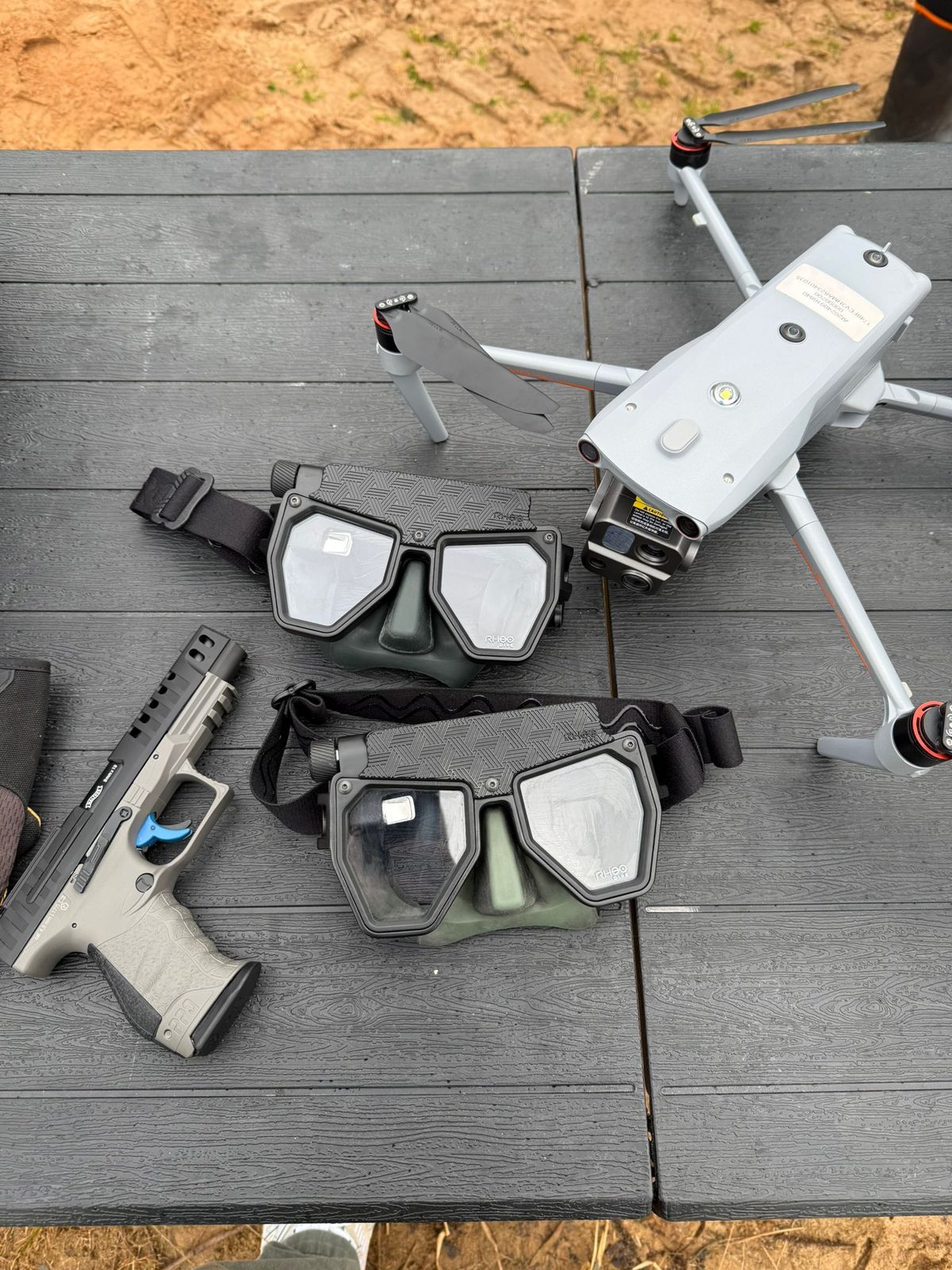 Two Rheo Dive masks on table alongside drone and tactical equipment — multi-unit field testing