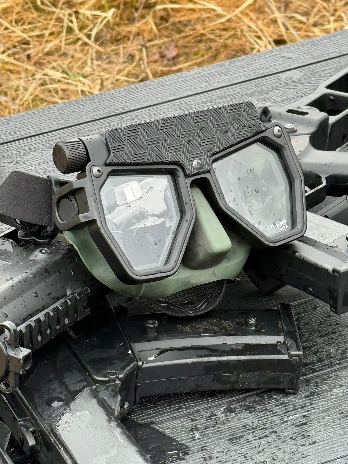 Rheo Dive mask on tactical gear — wet from field testing, water droplets on lens